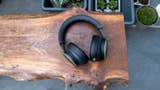 Microsoft's Xbox Wireless Headset sitting on a wooden bench outside with plants visible in the background